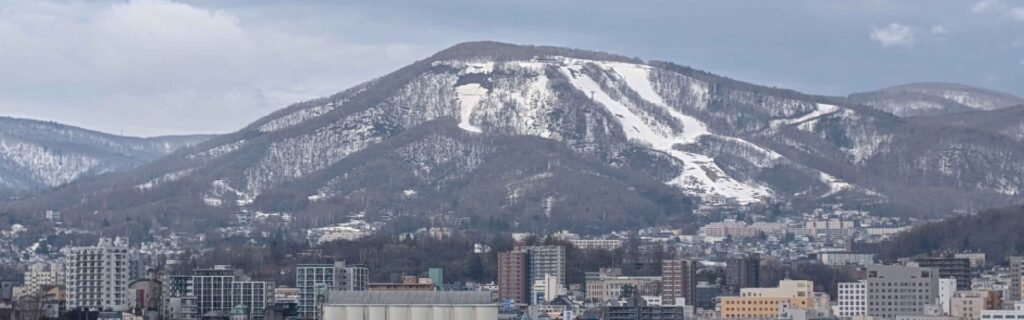 A panoramic view of snowy slopes above Otaru