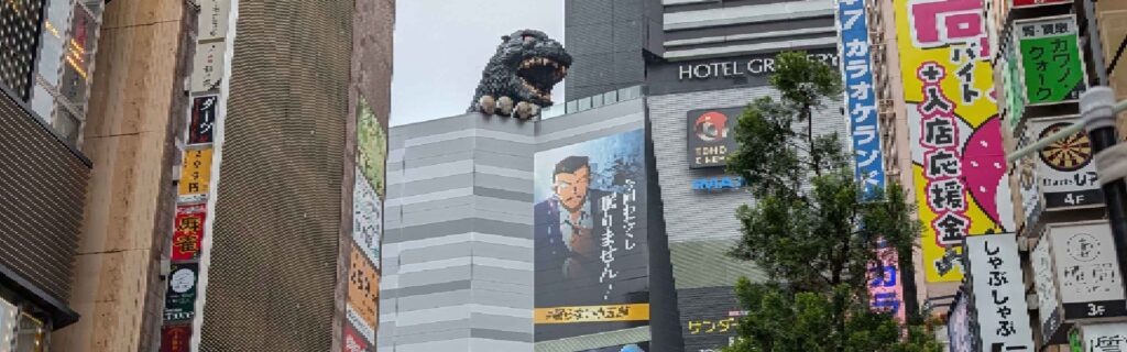 A wide view of the Godzilla statue above Toho Cinema in Shinjuku