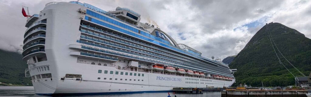 The Princess cruise ship sailing out of Åndalsnes fjord surrounded by calm blue waters