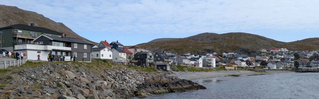 Colorful hillside homes along the rocky coastline