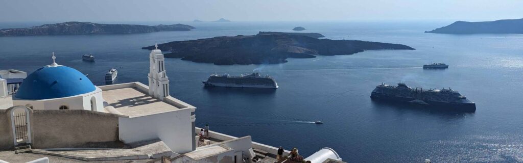 Panoramic view of Santorini caldera with cruise ships