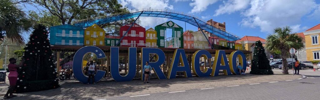 The Curacao landmark sign with holiday decorations and colorful house displays
