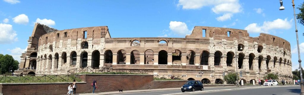 Wide daytime view of the Colosseum from across the street in Rome