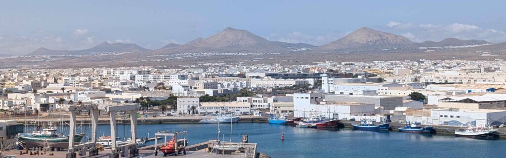 Panoramic view of Arrecife with harbor and volcanic landscape