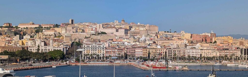 Panoramic skyline of Cagliari from Bastione Santa Croce with harbor and Castello hill.